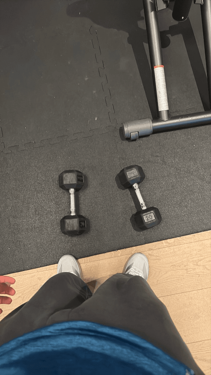 Saai standing beside dumbbells at the gym while cloud agents continue working